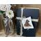 This image shows a bundle of vintage books tied together with twine. The books are decorated with a natural birch bark tag tag. 